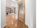 Inviting space with a fireplace, hardwood floors, and a doorway with glass panel at 1210 E Colfax Ave # 301, Denver, CO 80218