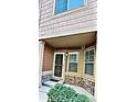 Charming covered front door with sidelight windows and decorative stone accents at 23525 E Platte Dr # 10B, Aurora, CO 80016