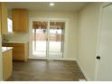 Dining area with wood floors, sliding glass door, and access to the patio at 3825 E 123Rd Ave, Thornton, CO 80241