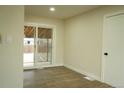 Bright living room with wood floors, a sliding glass door, and a view to the backyard at 3825 E 123Rd Ave, Thornton, CO 80241