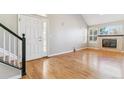 Living room with hardwood floors, fireplace, and view of the front door at 2503 S Toledo Way, Aurora, CO 80014