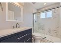 Modern bathroom with a large walk-in shower and dark vanity at 3227 N Steele St, Denver, CO 80205