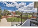 Deck view of yard, wooden fence, and fire station in the distance at 3227 N Steele St, Denver, CO 80205