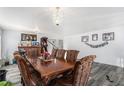 Formal dining room featuring hardwood table with seating for eight and a stylish light fixture at 21093 E 53Rd Ave, Denver, CO 80249