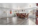 Spacious dining room with updated gray vinyl flooring and large windows for natural light at 21093 E 53Rd Ave, Denver, CO 80249