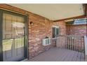 Exterior view of the unit's entrance with a wooden deck at 5401 E Warren Ave # 204, Denver, CO 80222