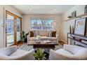 Bright living room with comfy seating, large window, and wooden floors at 2525 Nelson St, Lakewood, CO 80215