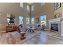 Bright living room with high ceilings, fireplace and ample windows at 9274 Viaggio Way, Highlands Ranch, CO 80126