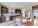 Stylish kitchen featuring dark cabinets, stainless steel appliances, and granite countertops at 5153 Andes Way, Denver, CO 80249
