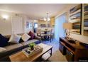 Comfortable living room with an attached dining area and view of the modern kitchen at 6380 S Boston St # 191, Greenwood Village, CO 80111