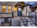 Charming home featuring brick facade, covered front porch, and well-maintained landscaping at 1571 Glencoe St, Denver, CO 80220