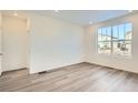 Bright and airy spare bedroom with large window and grey carpet at 4847 Astor Pl, Brighton, CO 80601