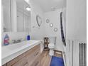 Cozy bathroom featuring tub, vanity and decorative mirror at 244 S Fetzer St, Byers, CO 80103
