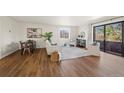 Sunlit living room with hardwood floors, stylish furnishings, and access to a private balcony at 1931 Centennial Dr # 1931, Louisville, CO 80027