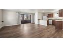 Open concept living room with wood floors, opens to the kitchen and balcony at 1931 Centennial Dr # 1931, Louisville, CO 80027