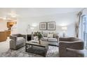 Comfortable living room showcasing neutral decor, a couch, and access to outdoor balcony at 13093 W Cedar Dr # 121, Lakewood, CO 80228