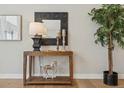 Console table decor featuring stylish mirror, lamp, candles, and wooden horse accents at 1361 Art Dr, Berthoud, CO 80513