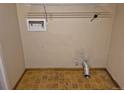 Laundry room with yellow tiled floor and open wall features at 5171 S Quintero St, Centennial, CO 80015