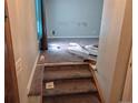 Stairway leading to living room with carpeted floors and blue curtains at 5171 S Quintero St, Centennial, CO 80015