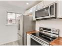 Stainless steel appliances and wood countertops in this kitchen at 1445 Yosemite St # 12, Denver, CO 80220