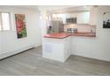 Updated kitchen with stainless steel appliances and a breakfast bar at 1445 Yosemite St # 12, Denver, CO 80220