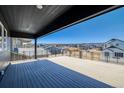 Expansive roof deck with sleek railing offers panoramic views of the surrounding neighborhood and distant mountains at 8633 Middle Fork St, Littleton, CO 80125