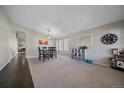 Spacious living room with natural light and a dining table at 20898 E Hamilton Ave, Aurora, CO 80013