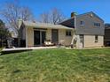 Back exterior view of the house, patio and a large grassy yard at 4609 S Kalispell Way, Aurora, CO 80015