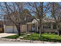 Charming two-story home with a well-manicured front yard and a two car garage at 4609 S Kalispell Way, Aurora, CO 80015