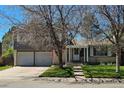 Charming two-story home with attached two-car garage, brick and siding and a well-maintained lawn at 4609 S Kalispell Way, Aurora, CO 80015