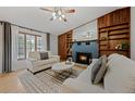 Comfortable living room with a blue brick fireplace, built-in shelving, and a stylish geometric rug at 7563 Lamar Ct, Arvada, CO 80003