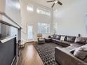 Spacious living room with vaulted ceilings, large windows, fireplace, hardwood floors and ample seating at 11811 Lewiston St, Commerce City, CO 80022