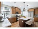 Bright kitchen with stainless steel appliances, modern white countertops and a central island at 2076 S Holly St # 1, Denver, CO 80222
