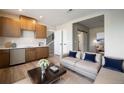 Inviting living room with a wet bar, hardwood floors, and comfortable contemporary furniture at 2076 S Holly St # 1, Denver, CO 80222