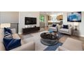 Spacious living room with modern furniture, hardwood floors, and an open layout at 2076 S Holly St # 1, Denver, CO 80222