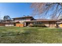 Spacious townhome with well-kept lawn, complemented by mature trees and a welcoming facade at 3742 S Granby Way, Aurora, CO 80014