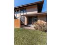 Close-up of townhome featuring well-maintained landscaping, covered entry, and privacy fence at 3742 S Granby Way, Aurora, CO 80014