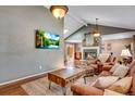 Inviting living room with hardwood floors, a cozy fireplace, and comfortable seating at 5620 E Cornell Ave, Denver, CO 80222