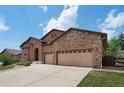 Stunning home with stone accents, a spacious three-car garage and extended driveway for ample parking at 15616 Soo Line Way, Monument, CO 80132