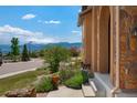 Exterior view of the house steps, landscaping, and a glimpse of the mountain landscape at 15616 Soo Line Way, Monument, CO 80132