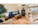 Comfortable living room featuring hardwood floors and an inviting blue sofa and decor at 16181 White Hawk Dr, Parker, CO 80134