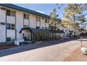 Exterior building view showcases architecture, greenery, and a covered walkway in a well-maintained setting at 8826 E Florida Ave # G11, Denver, CO 80247