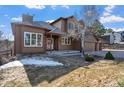 Charming home featuring a well-maintained lawn and attractive landscaping, with hints of snow adding character at 6374 Arapahoe Ct, Parker, CO 80134