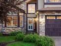 Close-up of home's front door and stone facade at 10954 W 100Th Way, Broomfield, CO 80021