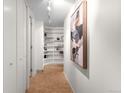 Bright hallway featuring built-in shelving and modern parquet wood flooring at 1201 N Williams St # 16A, Denver, CO 80218