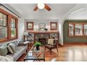 Cozy living room with a brick fireplace, hardwood floors, and natural light from the windows at 3611 N Vine St, Denver, CO 80205