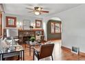 Bright living room featuring hardwood floors, a brick fireplace, and an archway leading to another room at 3611 N Vine St, Denver, CO 80205