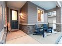 Inviting front porch with two blue chairs and a welcome mat at 9295 Dunraven Loop, Arvada, CO 80007