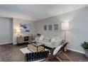 Charming living room with a comfortable sofa, stylish decor, and plenty of natural light for a relaxing ambiance at 5873 S Prince St # 117C, Littleton, CO 80120
