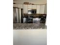 Kitchen features stainless steel appliances and granite countertops at 4396 Netherland St, Denver, CO 80249